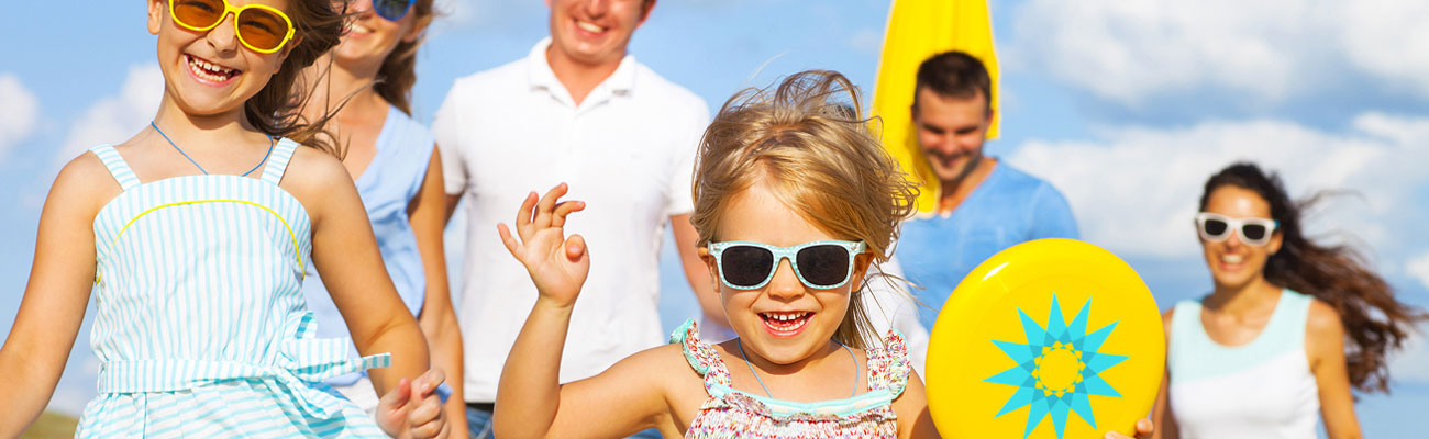 Family with children having fun at the beach