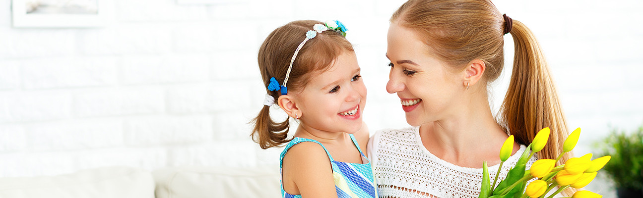 Little girl giving her mother a Creative Center Mother's Day card