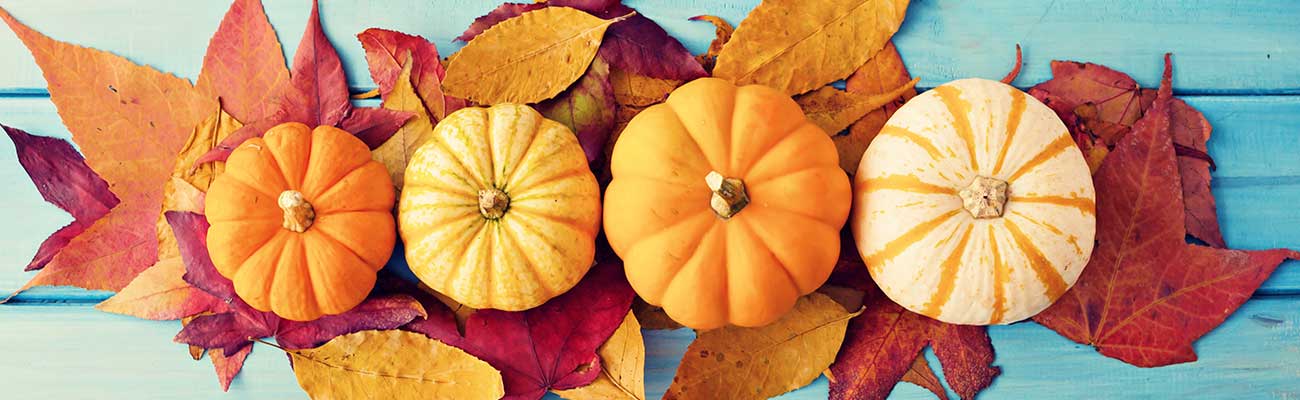 Festive leaves and pumpkins on a table